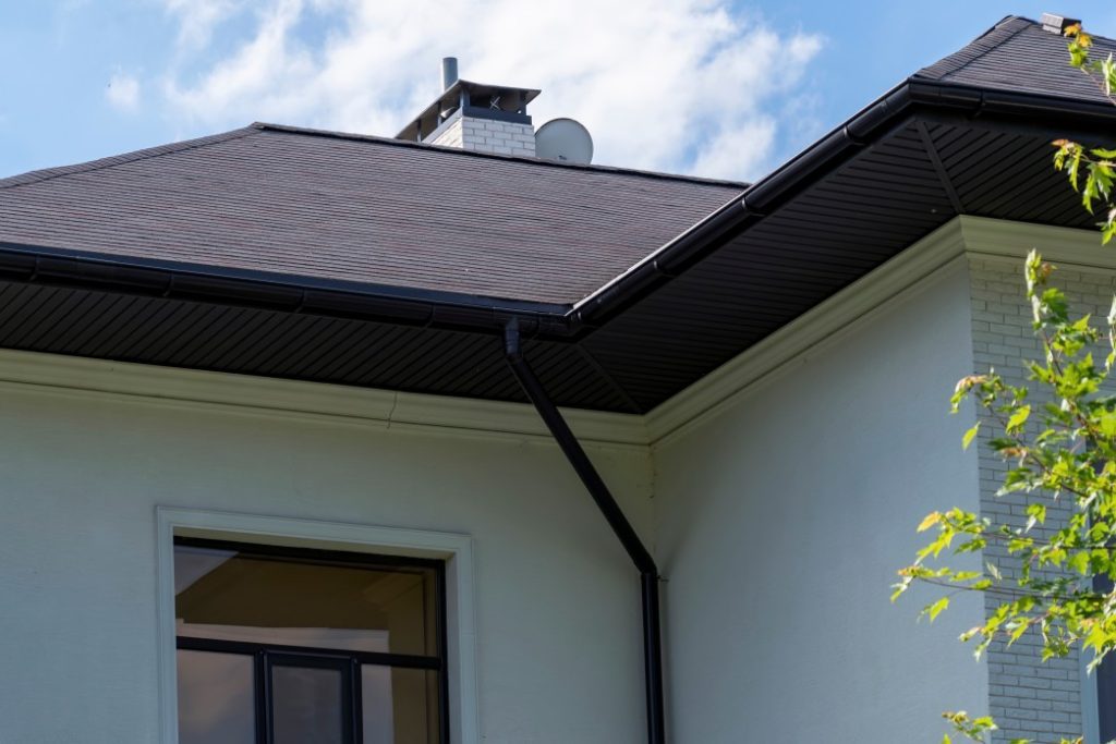 A shingled roof with a fascia board