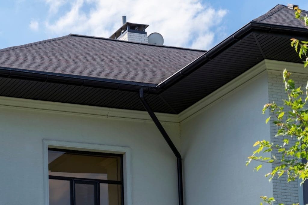 A shingled roof with a fascia board