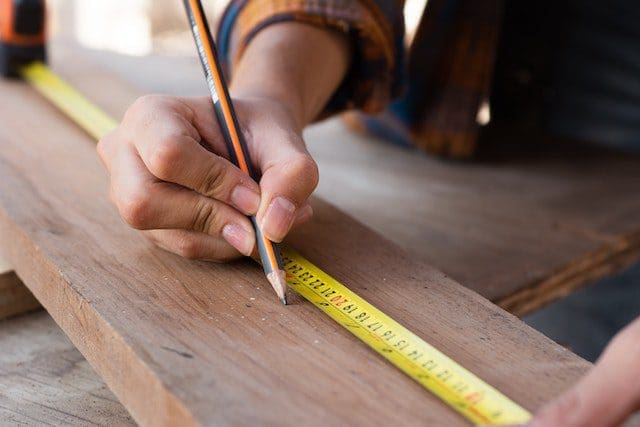 a person using a tool on a wood surface