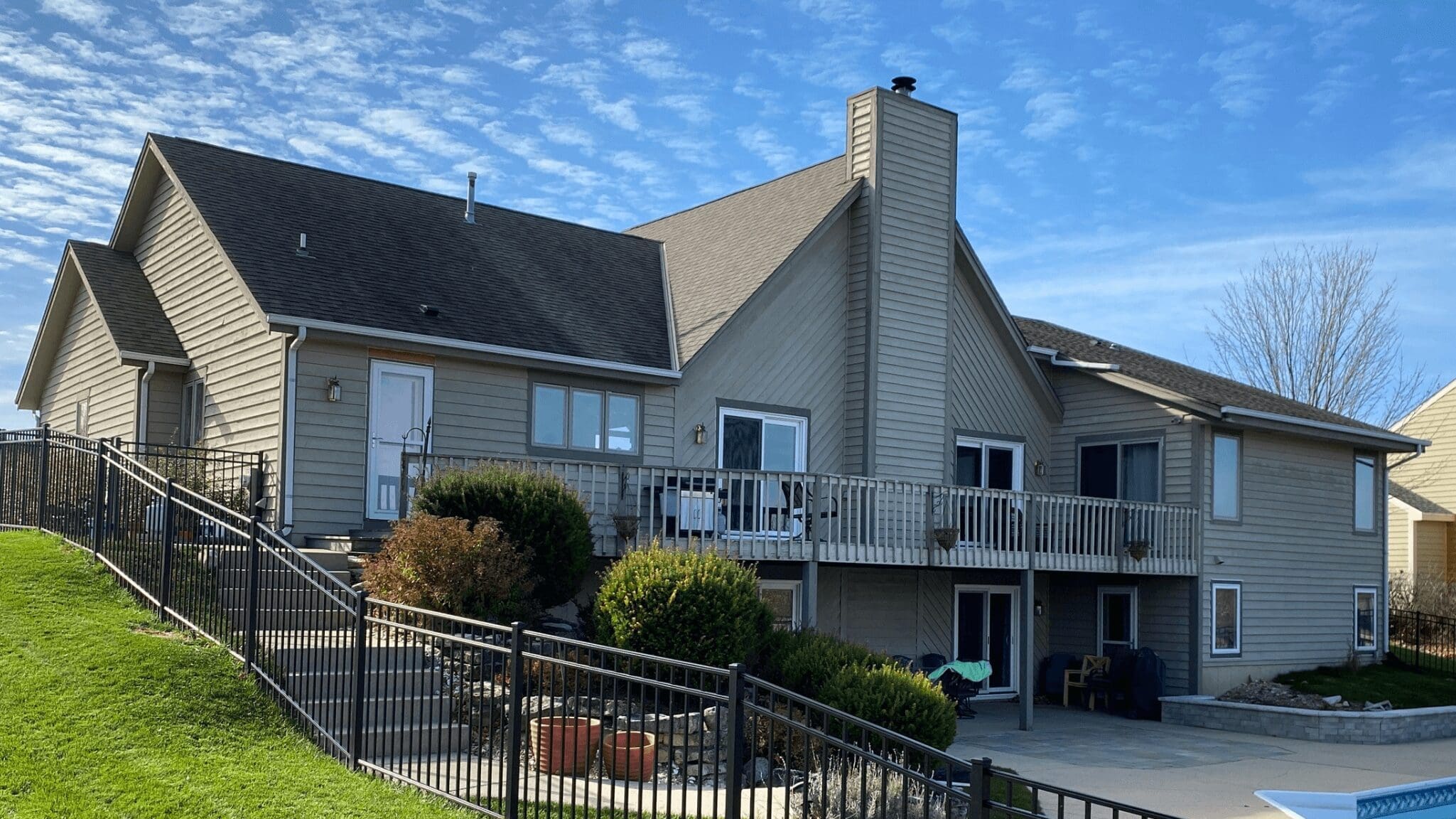house with railings, brown sidings and a pool showing color combinations