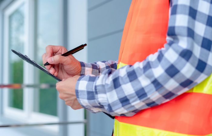 An insurance adjuster taking notes of important information for a claim