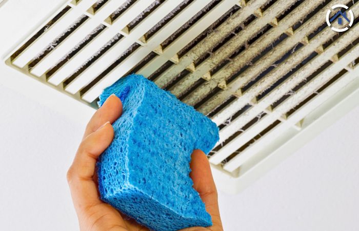 bathroom fan cleaning using a sponge