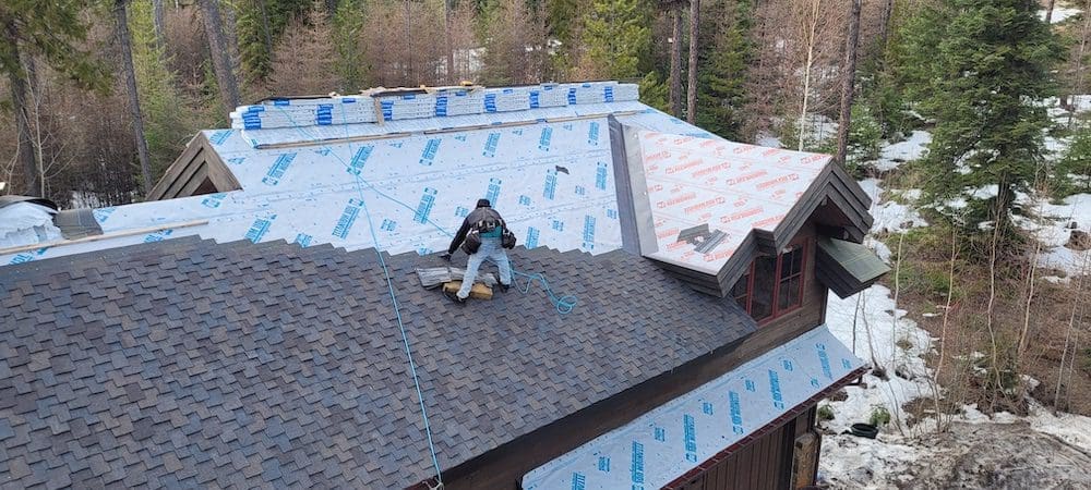 Guy on roof installing designer shingles