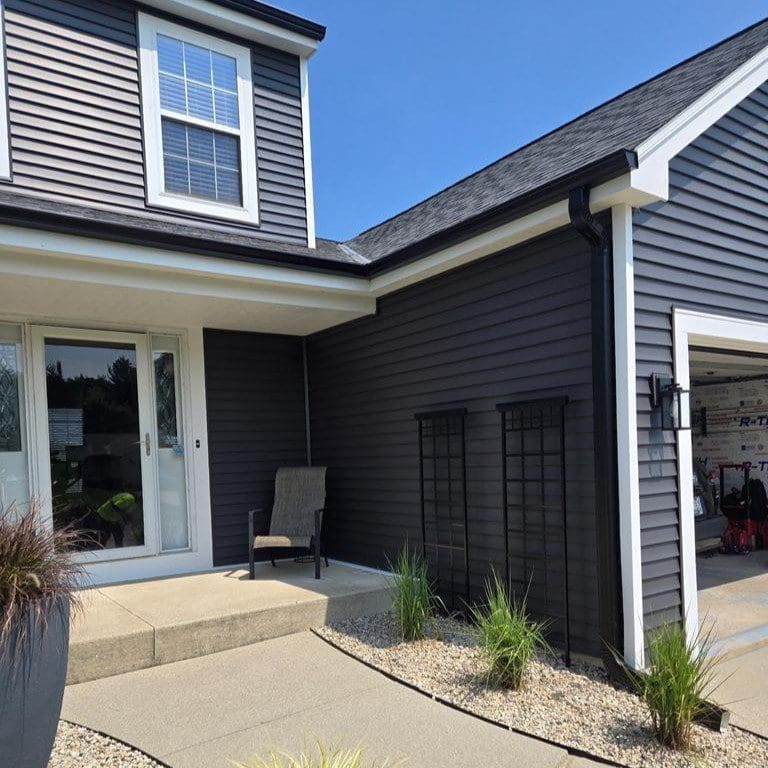 Entrance of Oak Creek home with elegant and highly functional solid downspout extension installed as part of new seamless gutter system by Modern Exterior