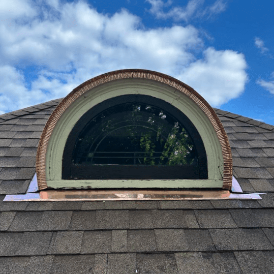 Front view of newly installed handcrafted copper dormer roof on historical Milwaukee home, completed by Modern Exterior