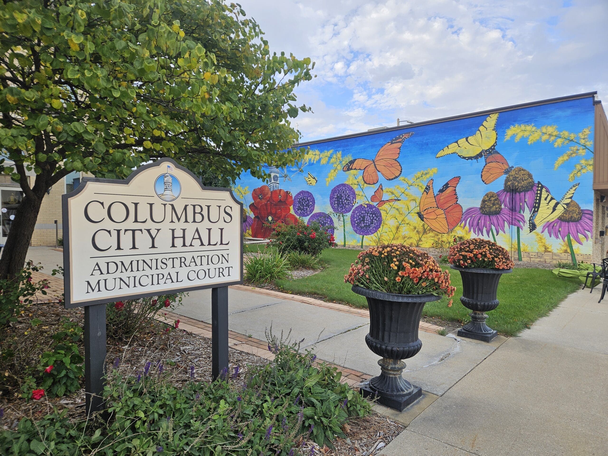 Columbus City Hall sign with painted wall behind in Columbus, WI, where Modern Exterior provides professional roofing and exterior remodeling services.