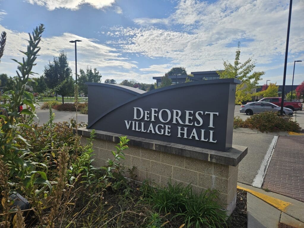 DeForest Village Hall sign, WI, part of the area where Modern Exterior provides expert roof replacement, siding, and gutter services for local homeowners.