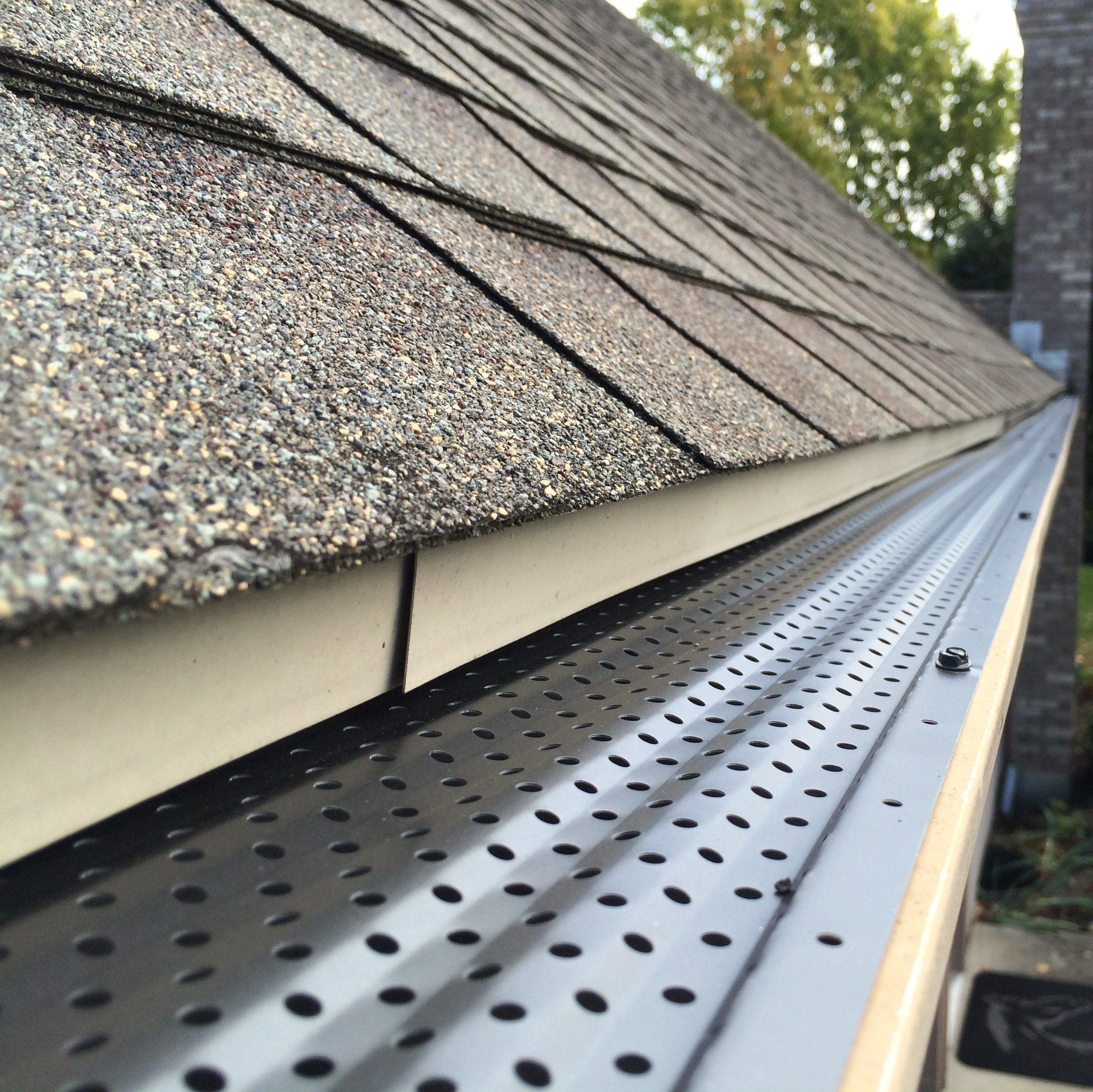 Gutter RX aluminum gutter guards showing how the perforated design keeps debris out while allowing water to drain efficiently.