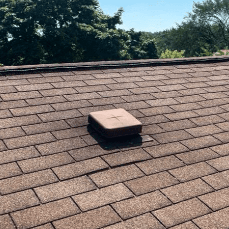 Old bathroom vent system on Milwaukee condo roof showing damage and leak prior to repair by Modern Exterior