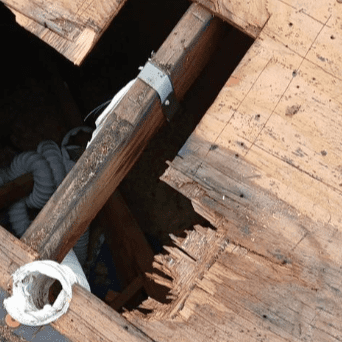 Damaged OSB roof decking with exposed vent pipe on Milwaukee condo prior to replacement by Modern Exterior