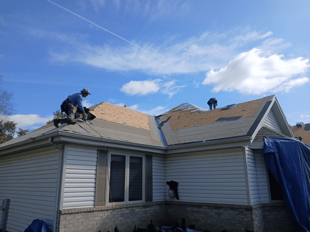 Modern Exterior crew installing ice and water barrier along roof valleys and edges for added leak protection on Hales Corners home