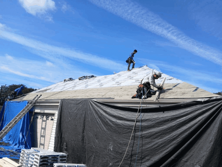 Modern Exterior crew installing synthetic roofing underlayment over roof deck after applying ice and water barrier on Hales Corners home