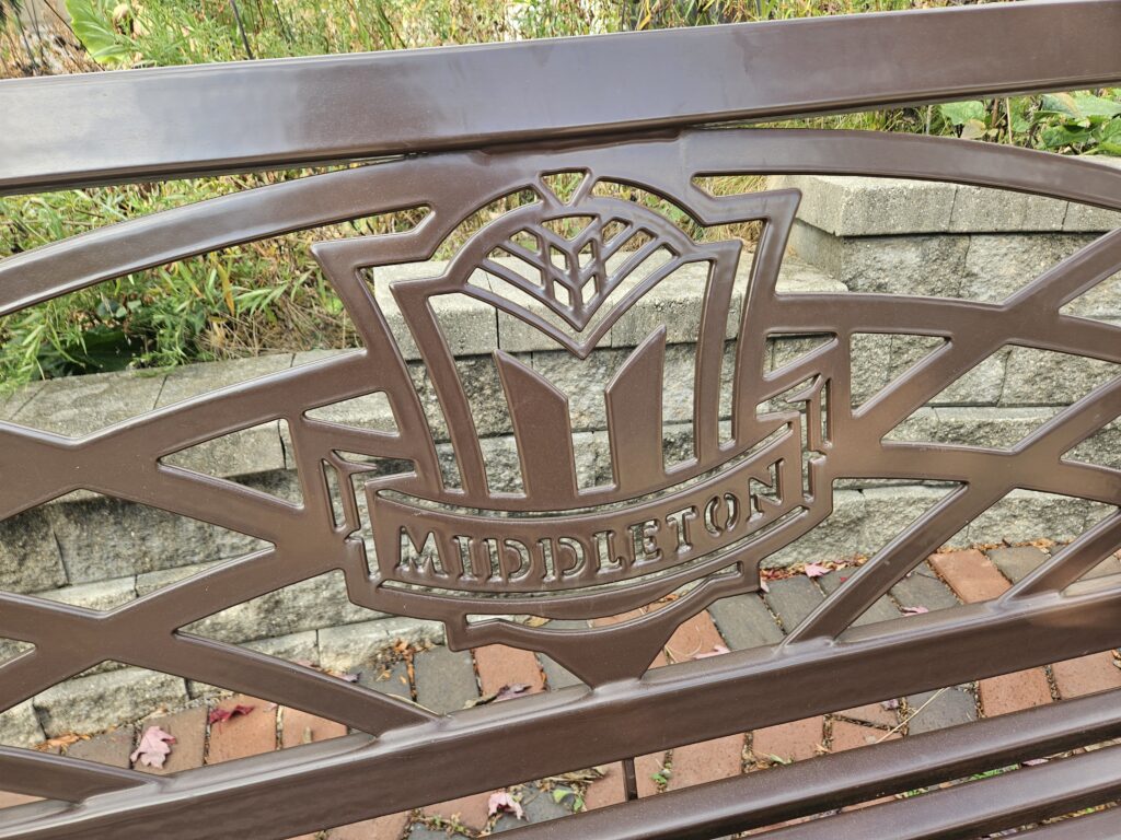 Close-up of a public bench with ‘Middleton’ inscription, city where Modern Exterior provides professional roofing and exterior renovation services.