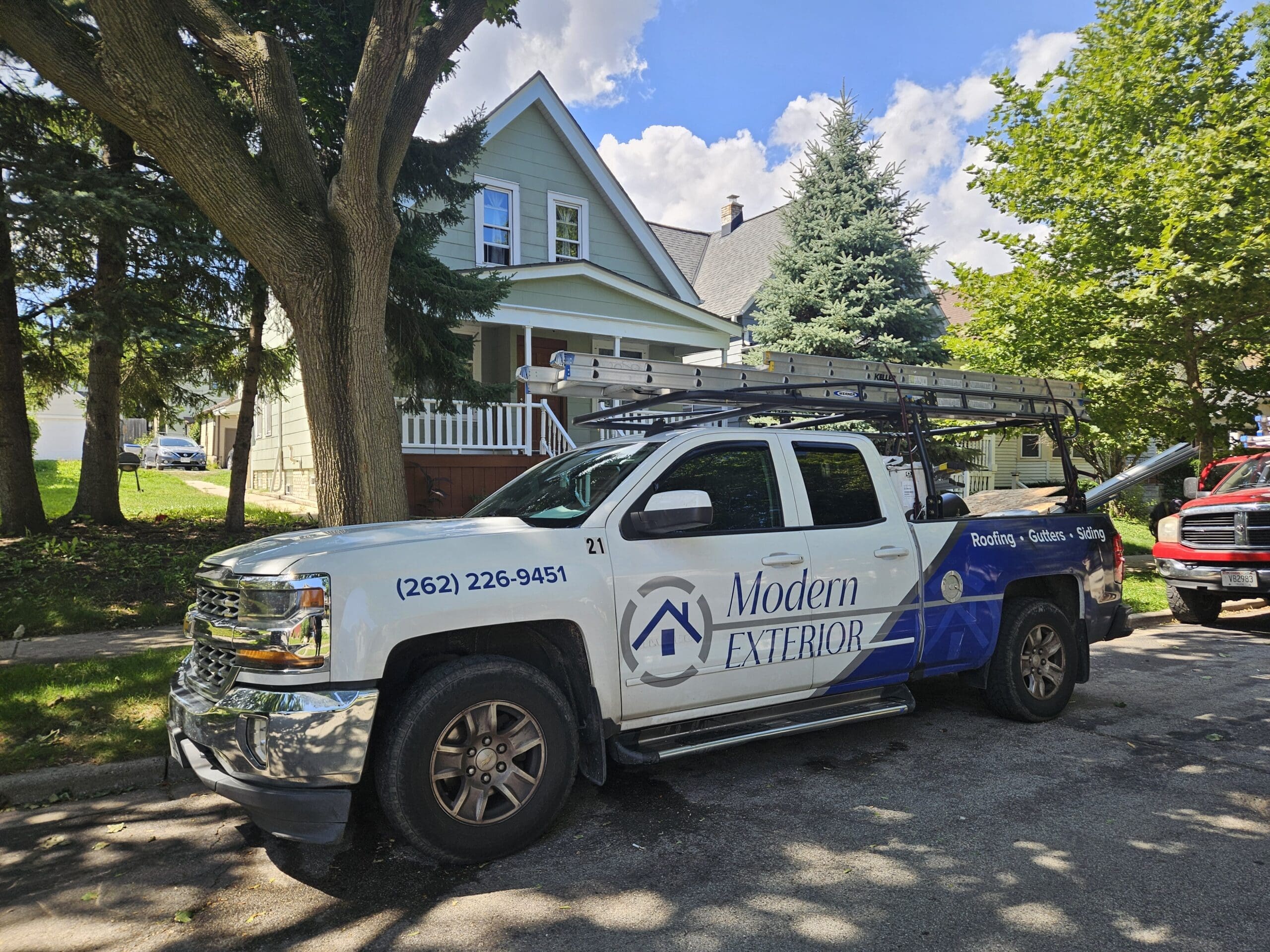 Modern Exterior truck parked in front of a Wisconsin home during a roofing and exterior renovation project