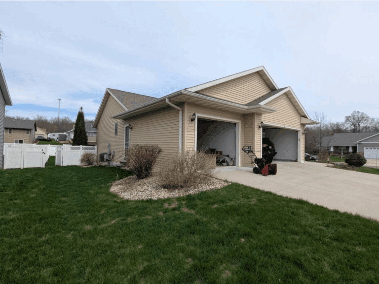 Front view of Evansville home before full exterior repair, including new siding, roof, gutters, and windows by Modern Exterior