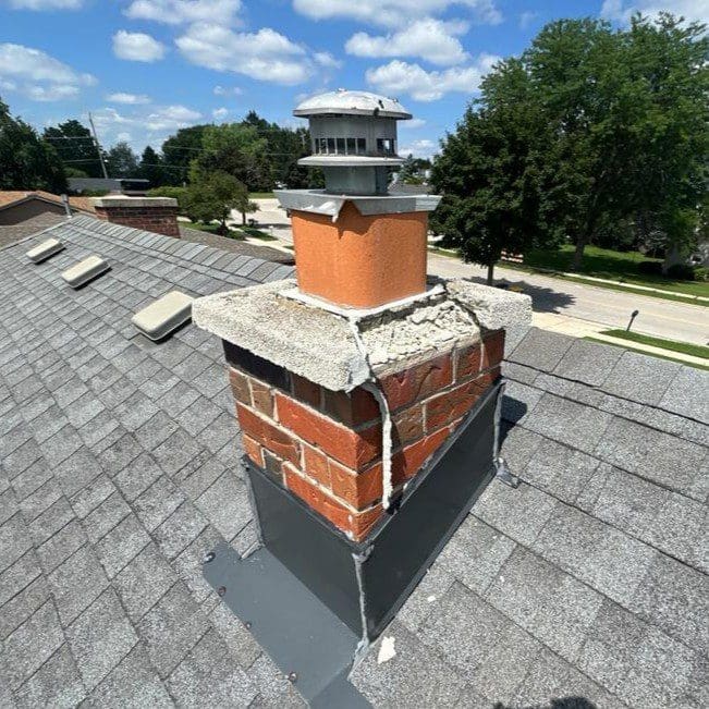 Broken concrete chimney cap on a Waukesha home before repair by Modern Exterior