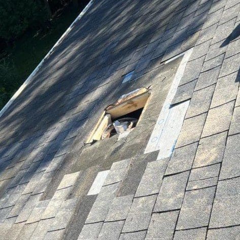 Hole left in roof after complete chimney tear-down on a Brookfield home by Modern Exterior, before roof patch and shingle replacement