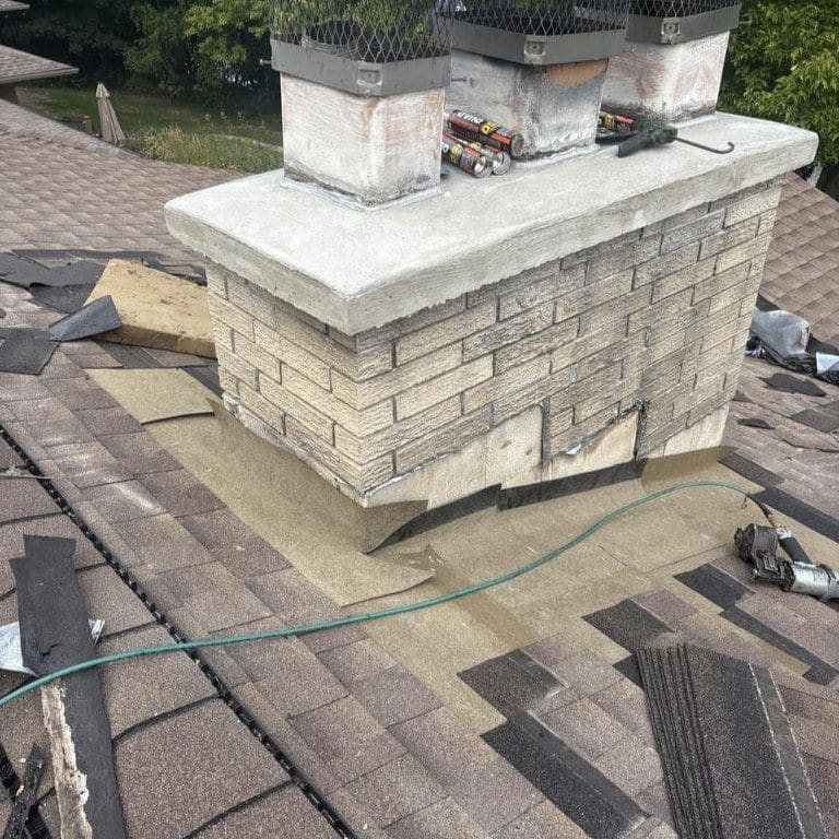 Ice and water barrier installed around chimney base on a Cedarburg home by Modern Exterior to prevent leaks and water damage