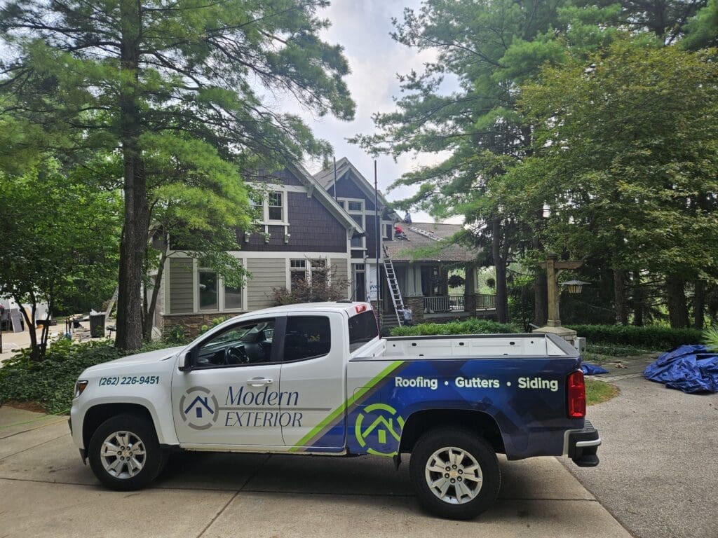Modern Exterior truck parked in front of a home during exterior renovation, showcasing professional roofing, siding, and gutter services.