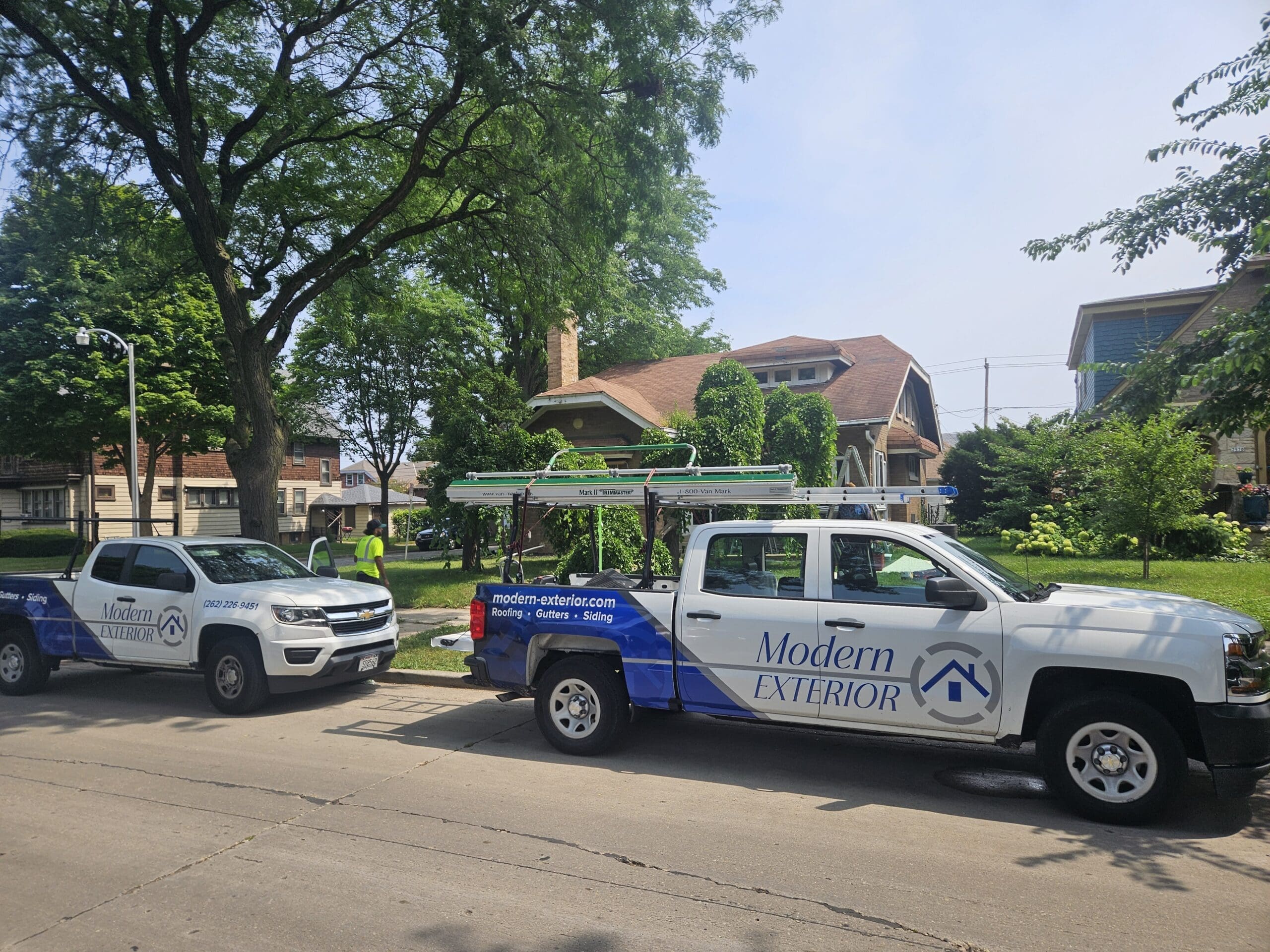 Modern Exterior truck parked in front of a Wisconsin home during a roofing and exterior renovation project