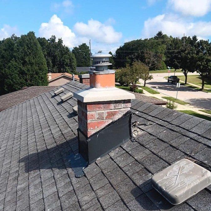 New brick chimney flue and concrete cap installed on Waukesha home after full chimney repair by Modern Exterior