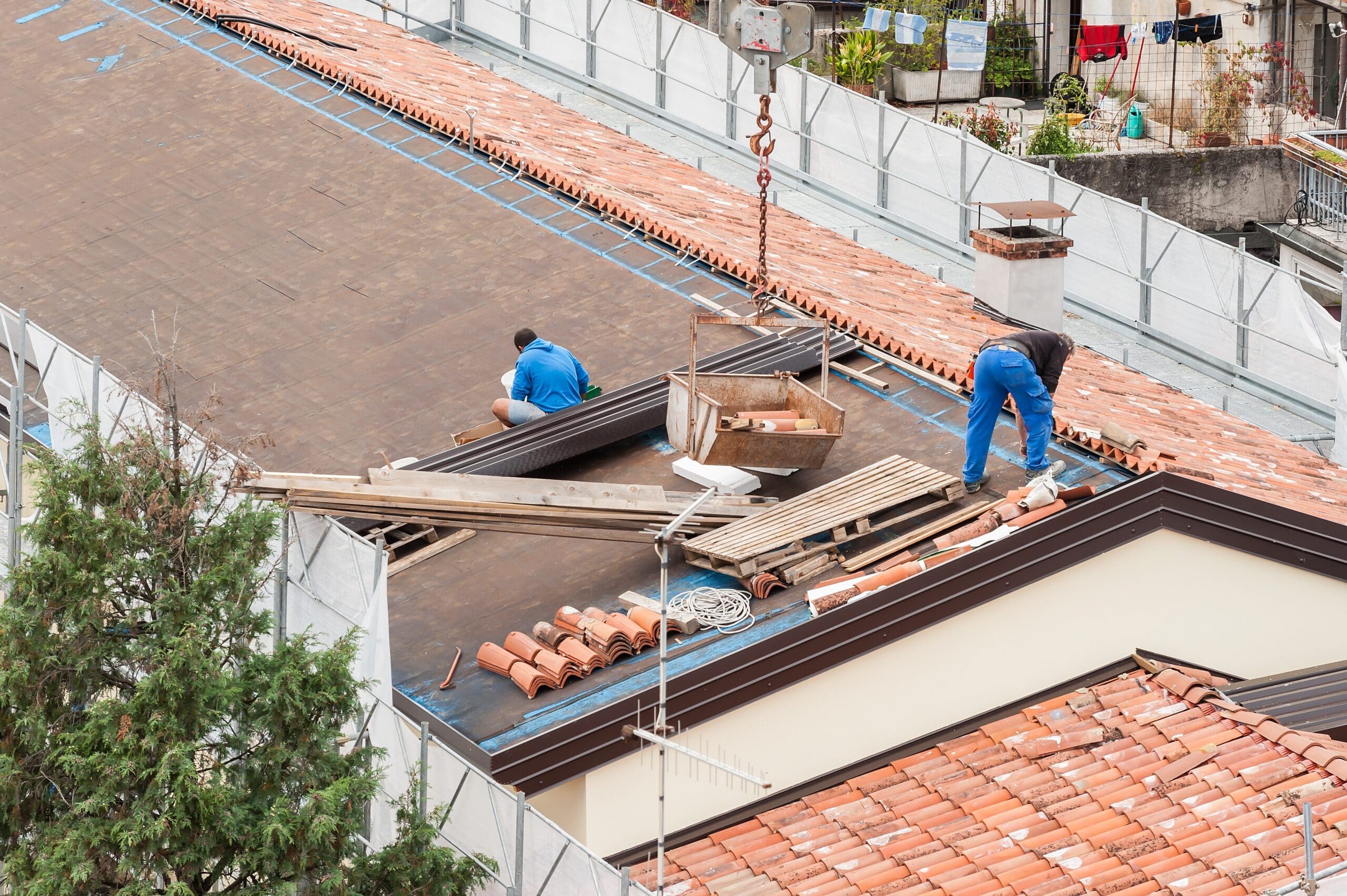 Workers in the construction of a roof. Building renovation.