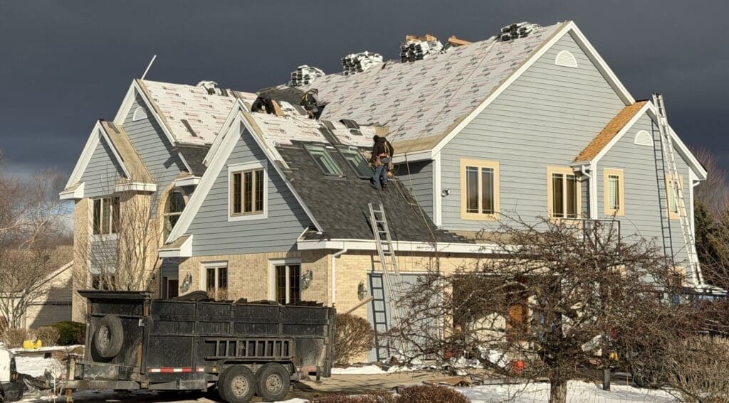 Roof installation in progress showing ice and water barrier, underlayment, and new Nordic shingles being installed on Brookfield home