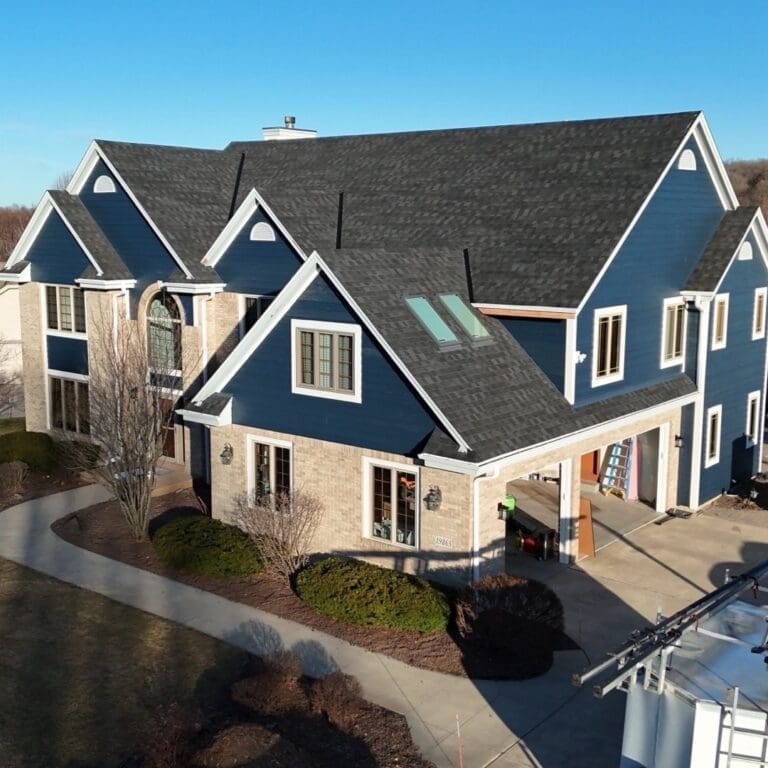 After photo from corner angle showcasing newly installed Nordic Granite Black roof and updated exterior on Brookfield home