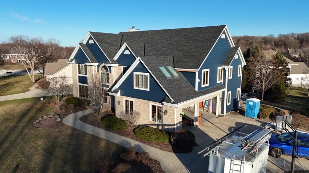 After photo from corner angle showcasing newly installed Nordic Granite Black roof and updated exterior on Brookfield home
