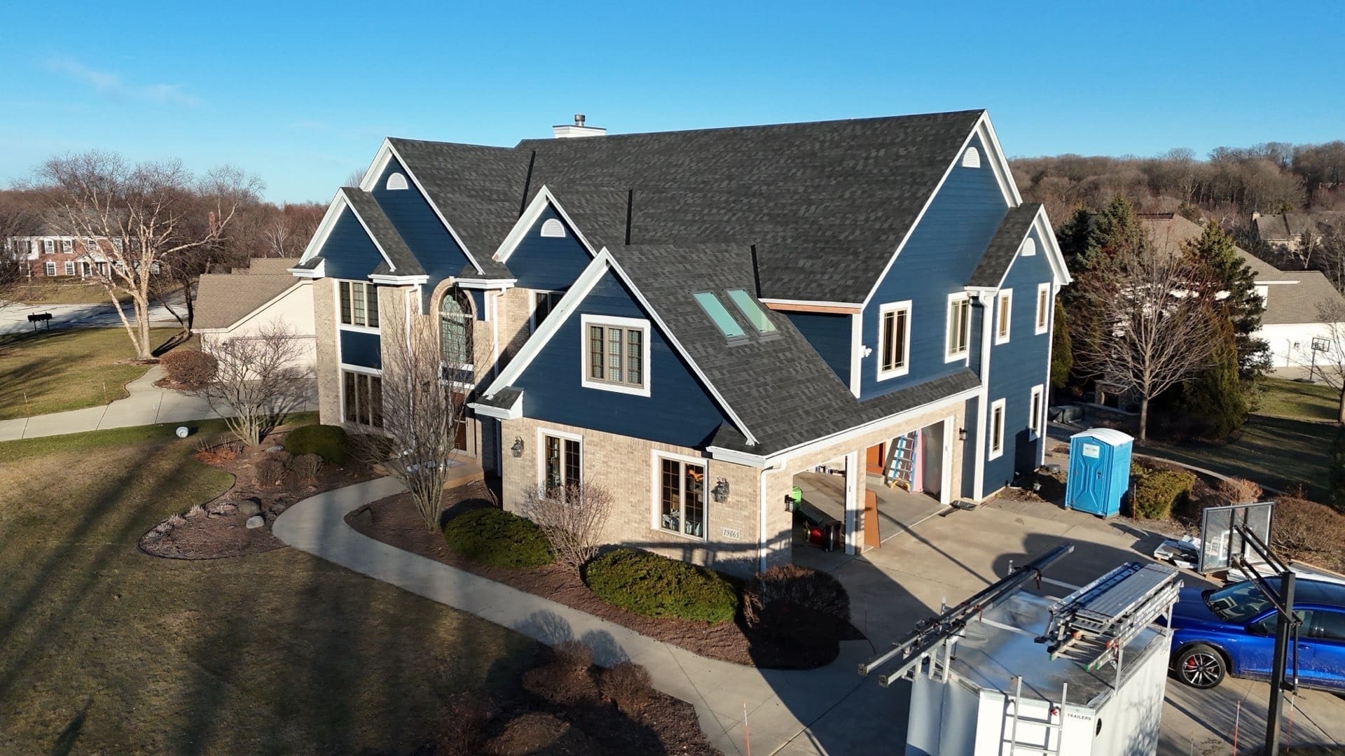 After photo from corner angle showcasing newly installed Nordic Granite Black roof and updated exterior on Brookfield home