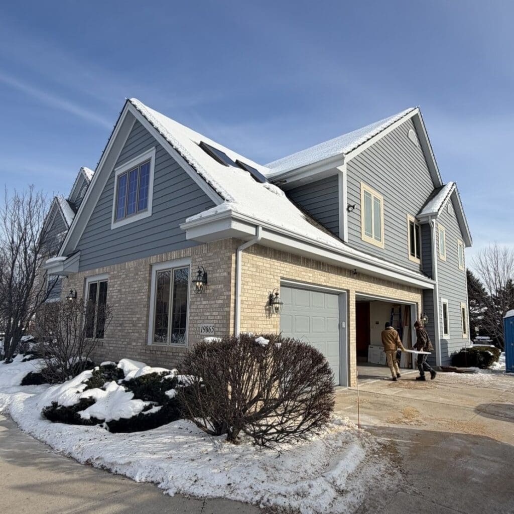 Before photo of snow-covered shingle roof in Brookfield, where melting snow contributed to active roof leaks prior to replacement