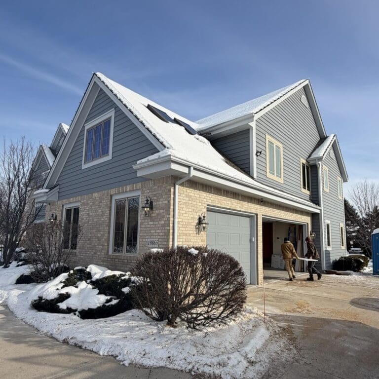 Before photo of snow-covered shingle roof in Brookfield, where melting snow contributed to active roof leaks prior to replacement