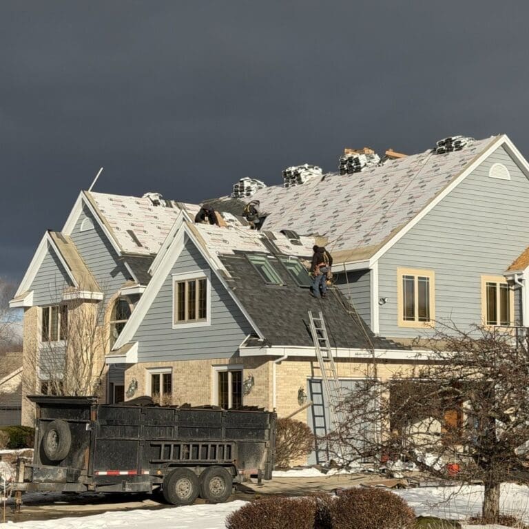 Roof installation in progress showing ice and water barrier, underlayment, and new Nordic shingles being installed on Brookfield home