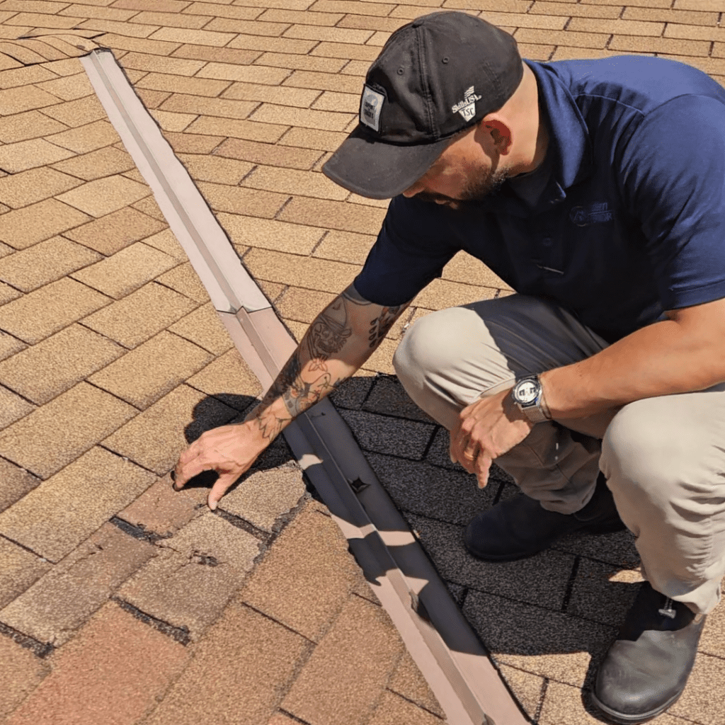 Modern Exterior roofing professional inspecting damaged shingles during a free roof inspection.