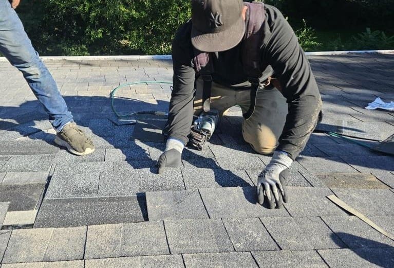 Seamlessly matched shingles installed over roof patch after chimney tear-down on a Brookfield home by Modern Exterior