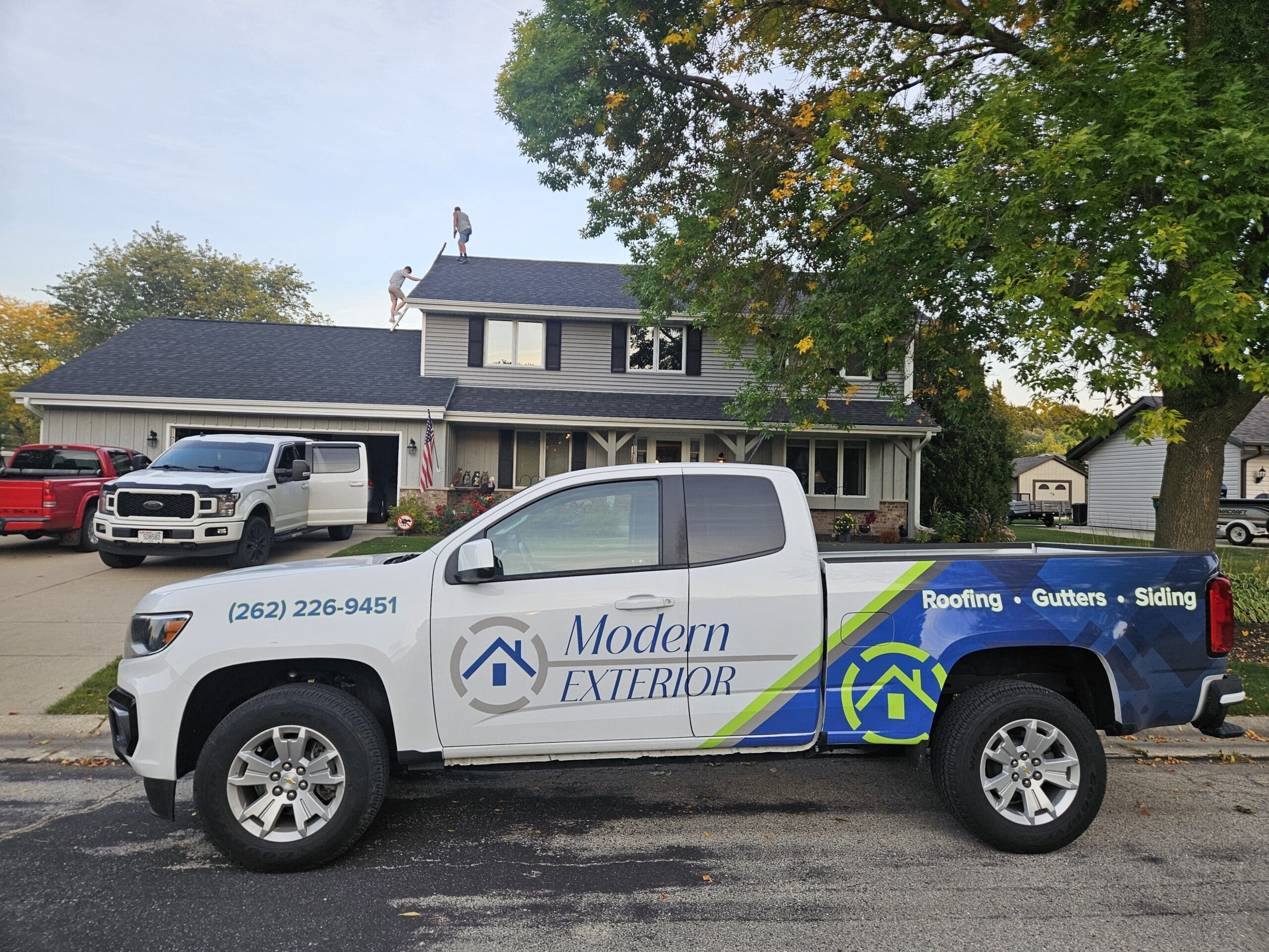 Modern Exterior roofing truck parked in front of a home in Wisconsin.